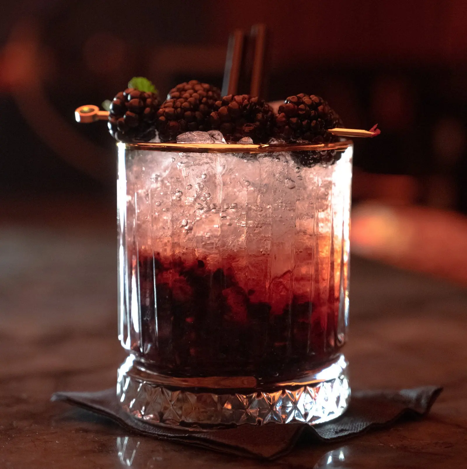A blackberry cocktail over crushed ice