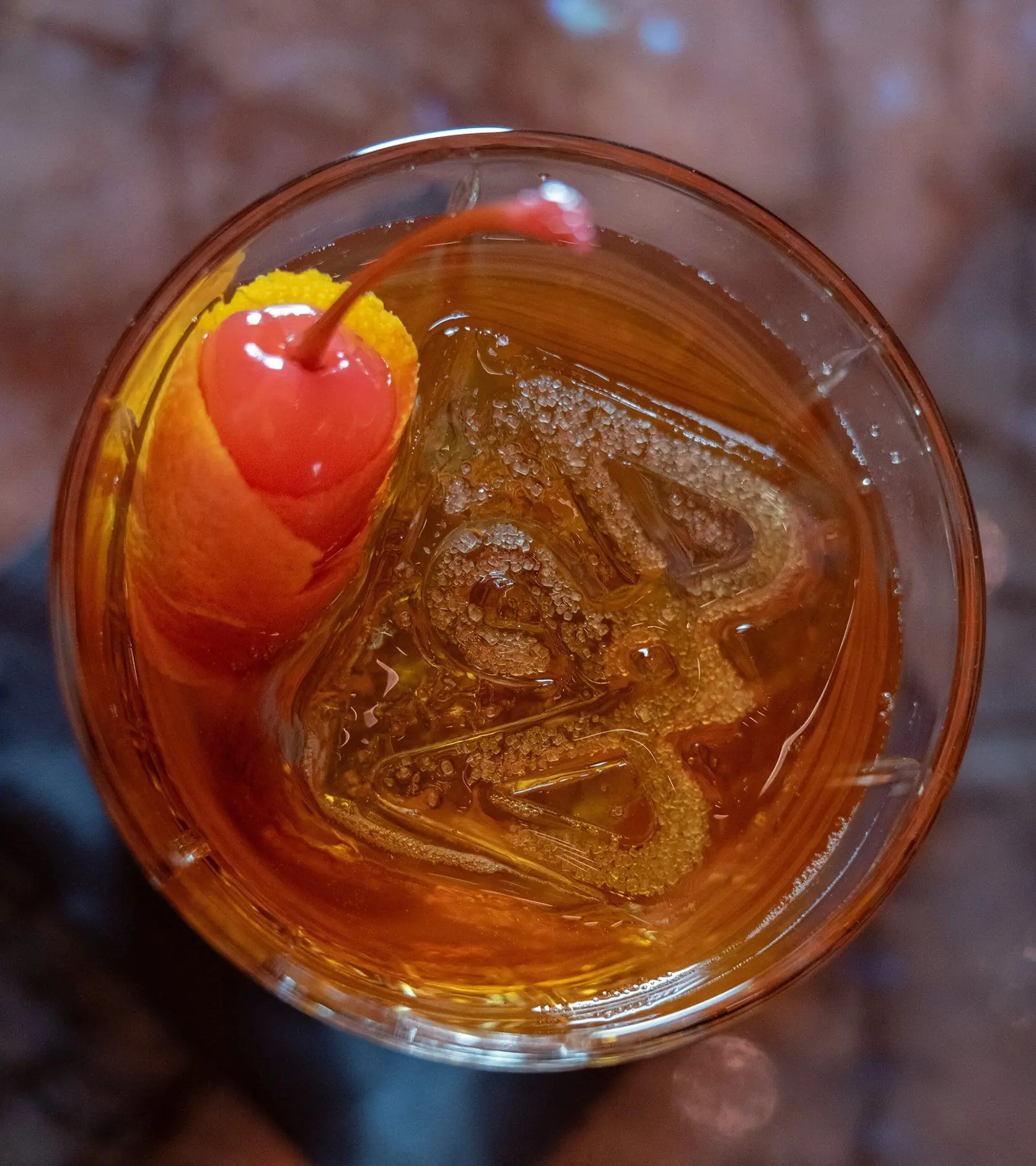 An amber cocktail served over clear ice