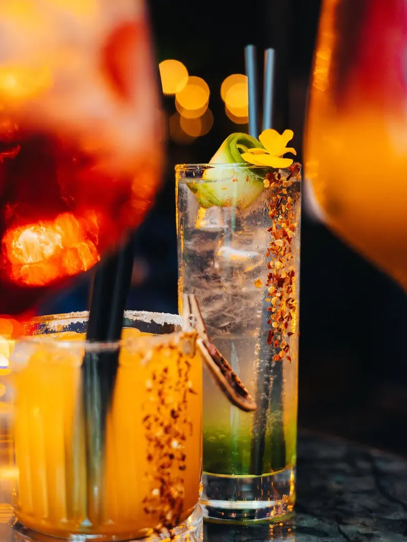 Two cocktails with chili and citrus at the bar