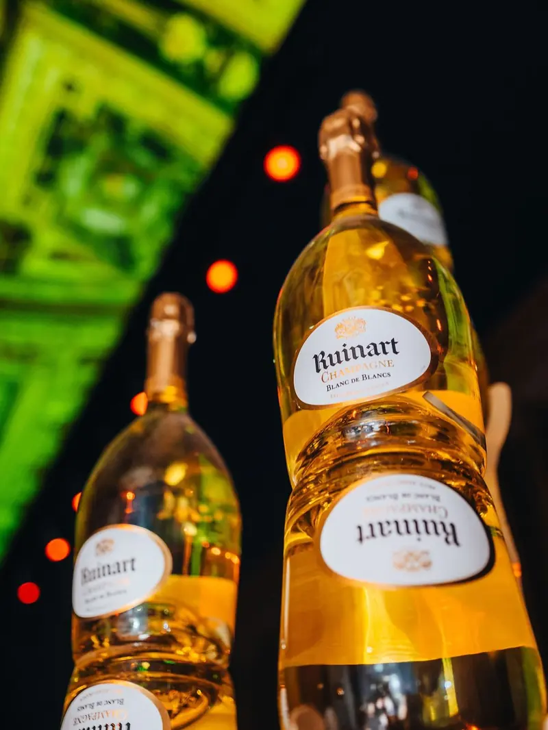 Ruinart bottles lit at the bar