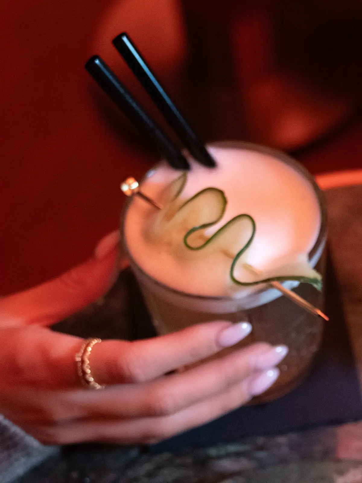 Two cocktails passed across the table at Mayfair